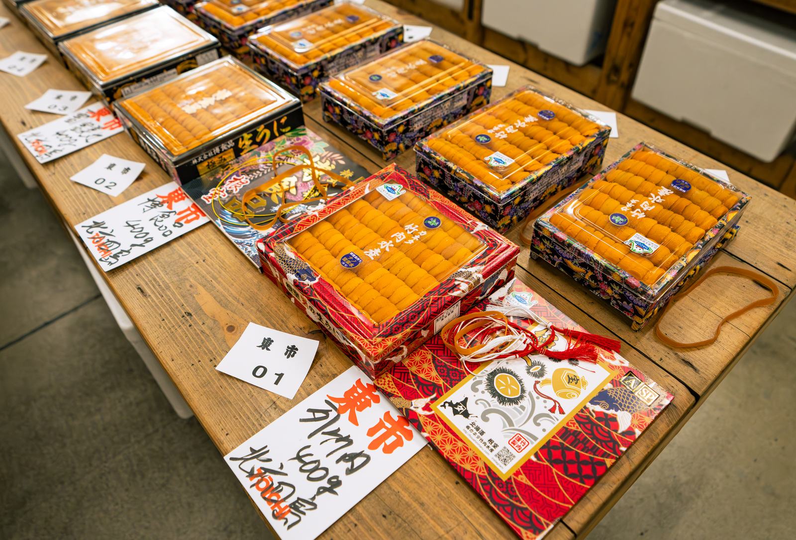 Nemuro uni boxes laid out with lot cards for the morning auction